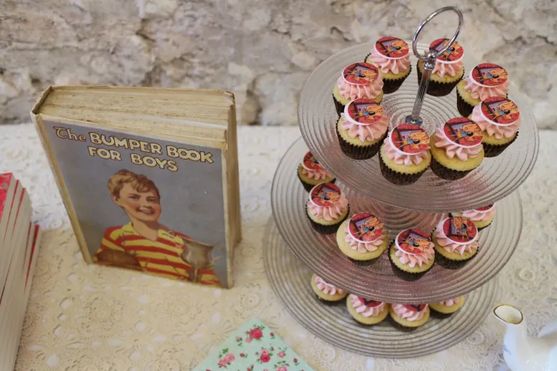 Lily-themed cupcakes alongside a vintage children's book