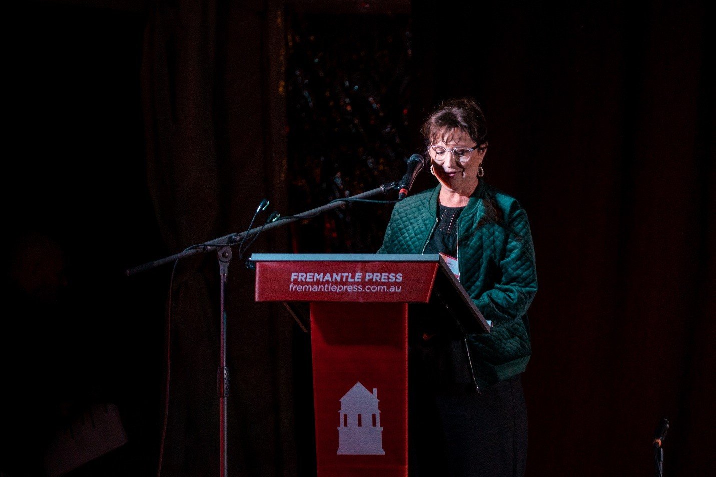 Paula speaking on stage at a Fremantle Press event