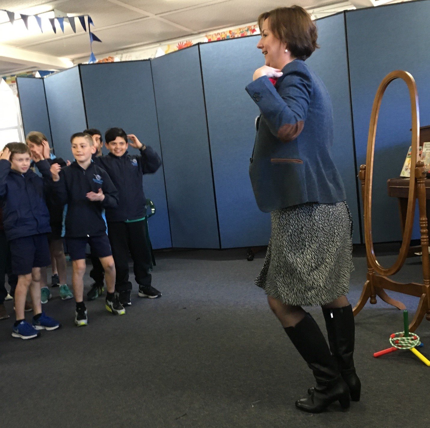 Paula acting out a scene with a mirror for a class of students