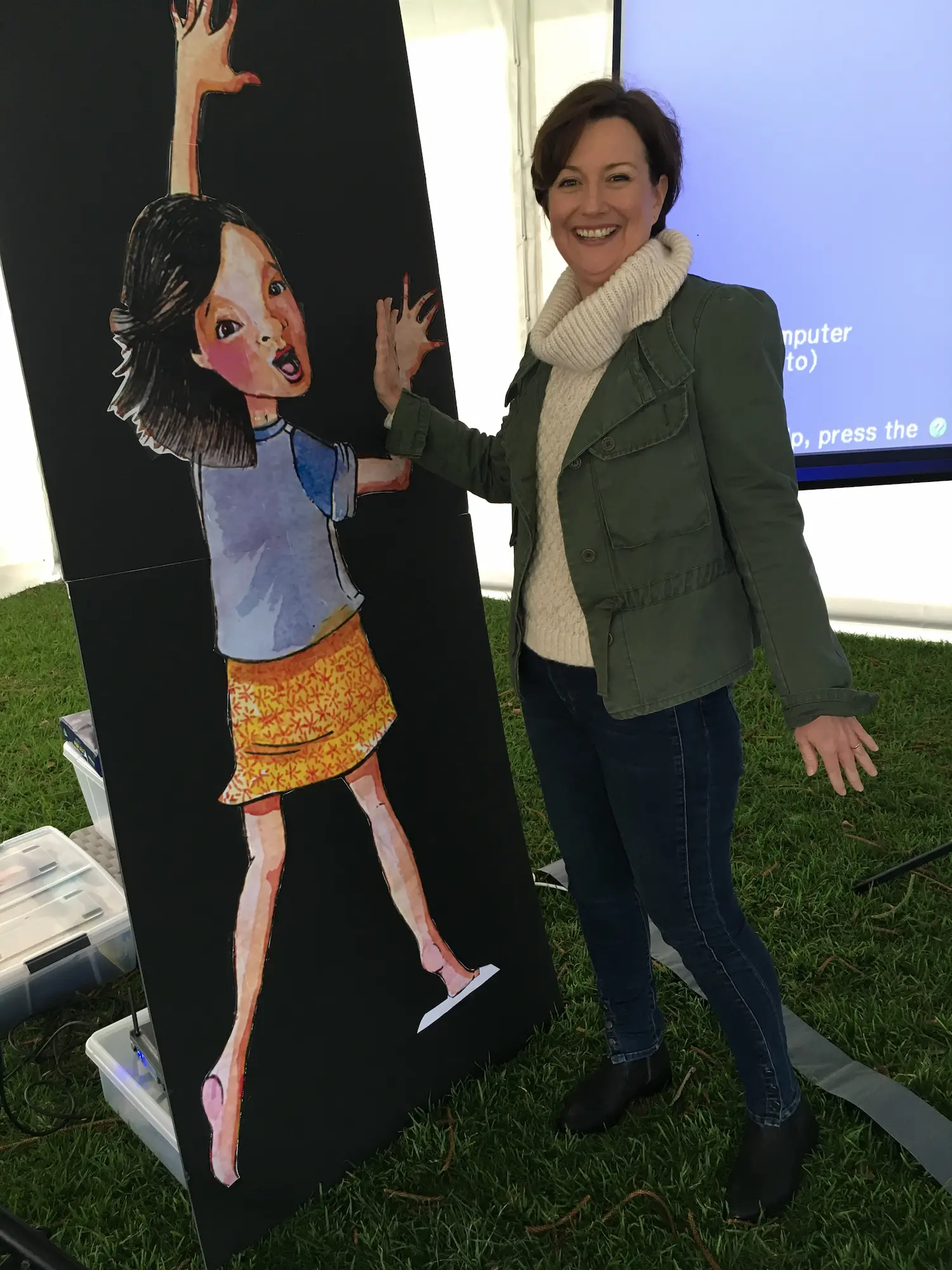Paula with a life-size cutout of Lily at a school event