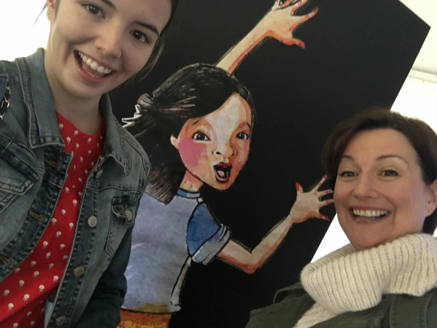 A student taking a selfie with Paula and the Lily cutout